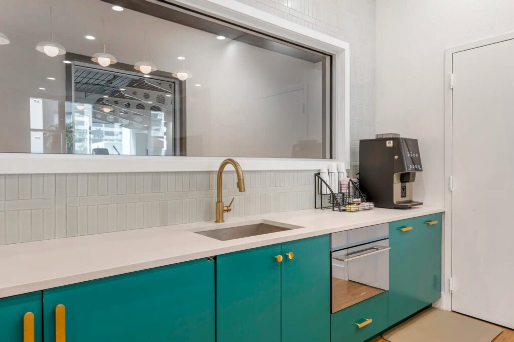 clubhouse kitchen area with coffee maker, sink, and microwave