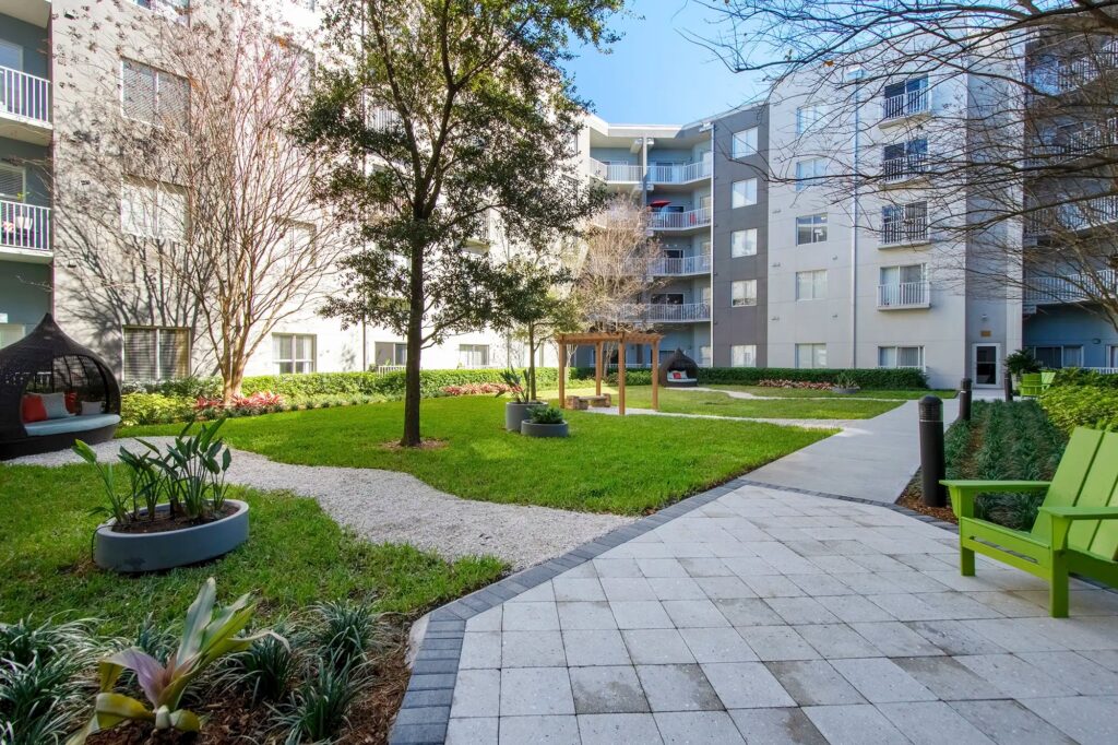 Courtyard with lots of grass and spaced out seating areas with gravel pathways