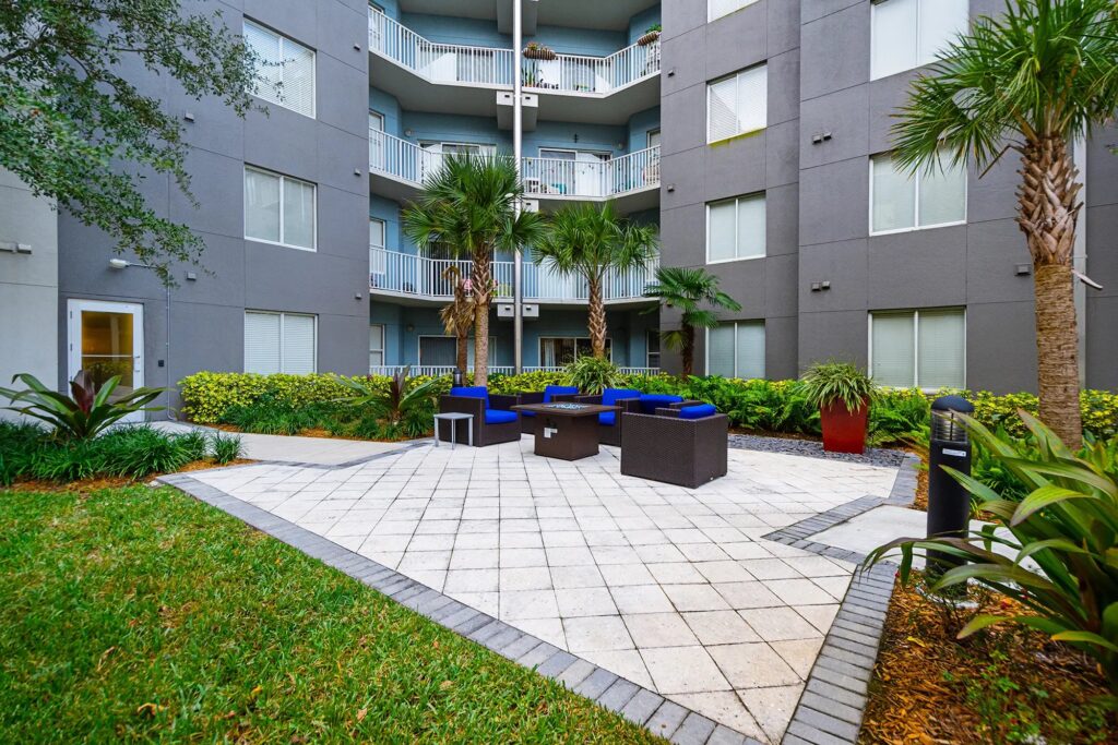 Open sitting area with palm trees.