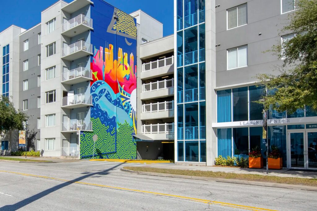 Exterior of leasing center with mural on the side of the building