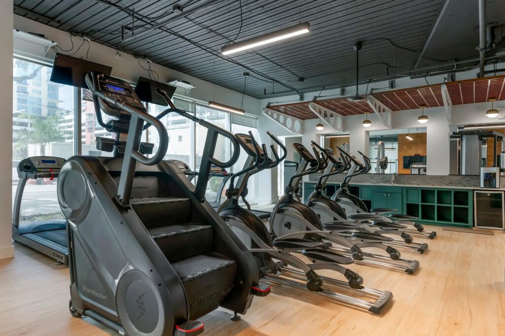 fitness center with cardio equipment and shelf storage