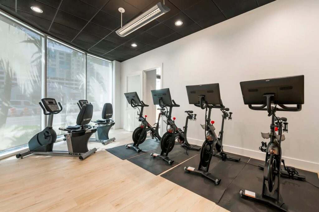 fitness center with cardio equipment and peleton bikes