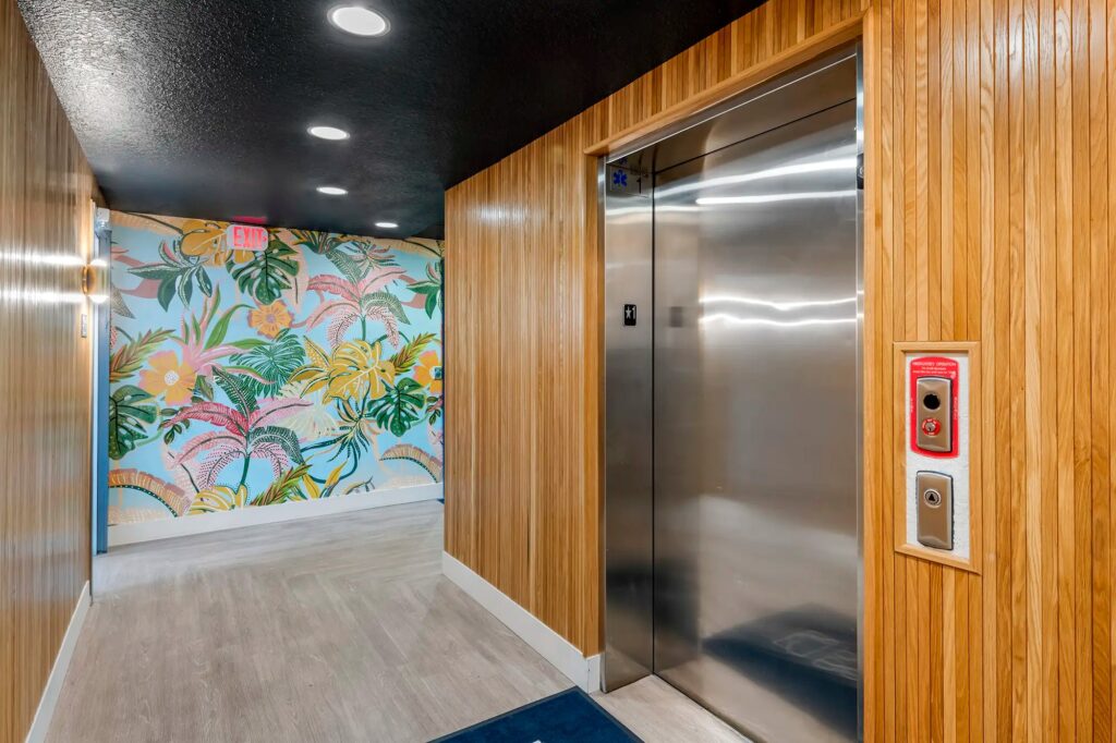 Interior elevator with wood walls and floral mural