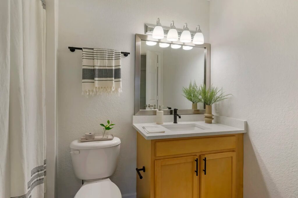 Bathroom with upgraded fixtures and large mirror