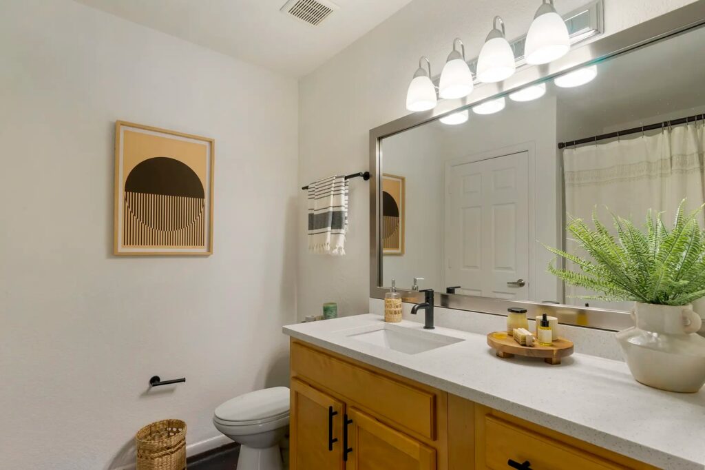 Bathroom with upgraded fixtures and large mirror