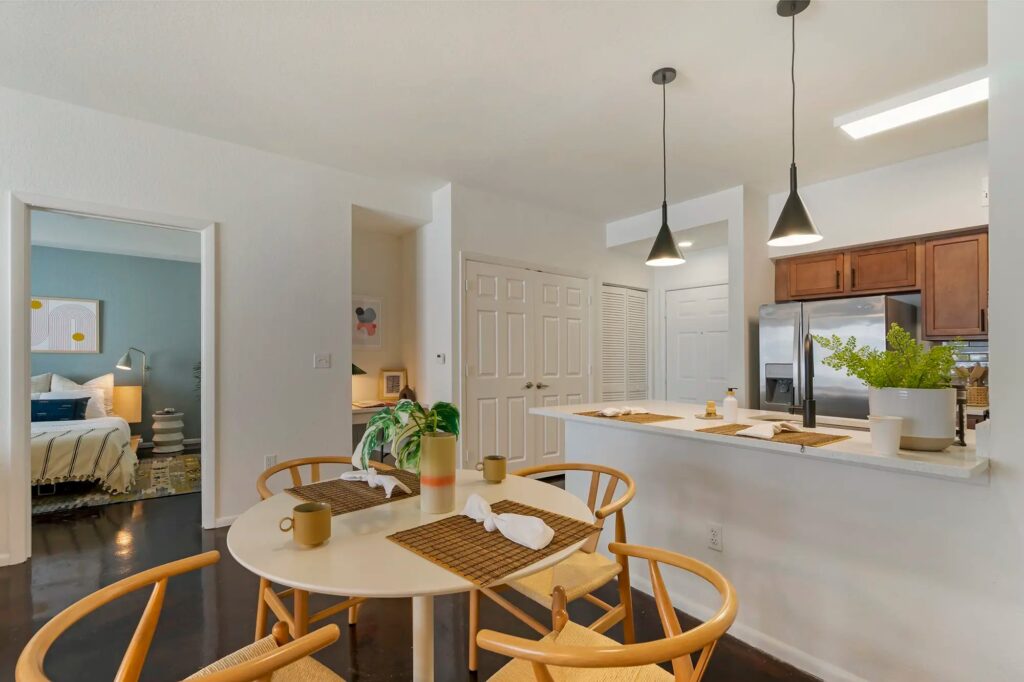 Dining room with kitchen to the right and access to the bedroom on the far left